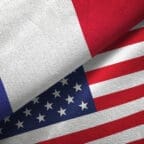 The flags of France and the United States overlapping, symbolizing relations between the two nations