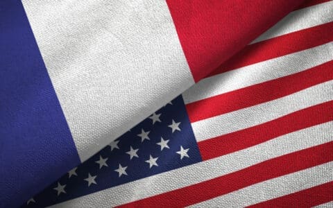 The flags of France and the United States overlapping, symbolizing relations between the two nations