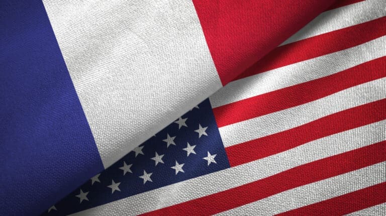 The flags of France and the United States overlapping, symbolizing relations between the two nations